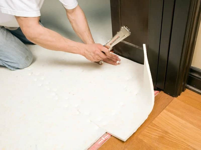 skilled professional installing a white underpad