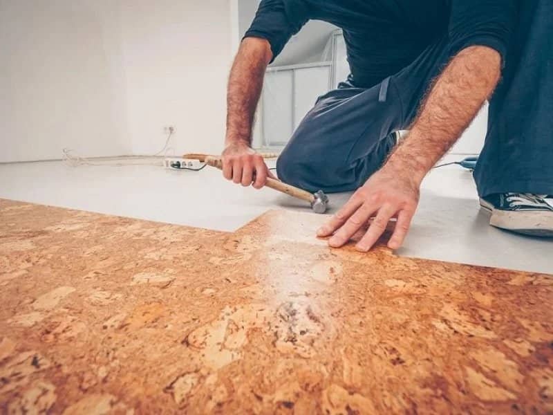 skilled professional installing cork flooring